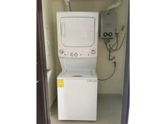 Compact laundry room with stacked washer dryer, water heater Panama Pacifico rental