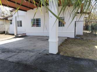 Single story house with front yard, guarded entrance and driveway at Las Villas de Penonomé Panama