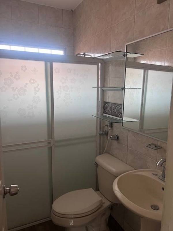 Spacious master bathroom with Jacuzzi tub, window, tile walls in Villa Zaita house Panama