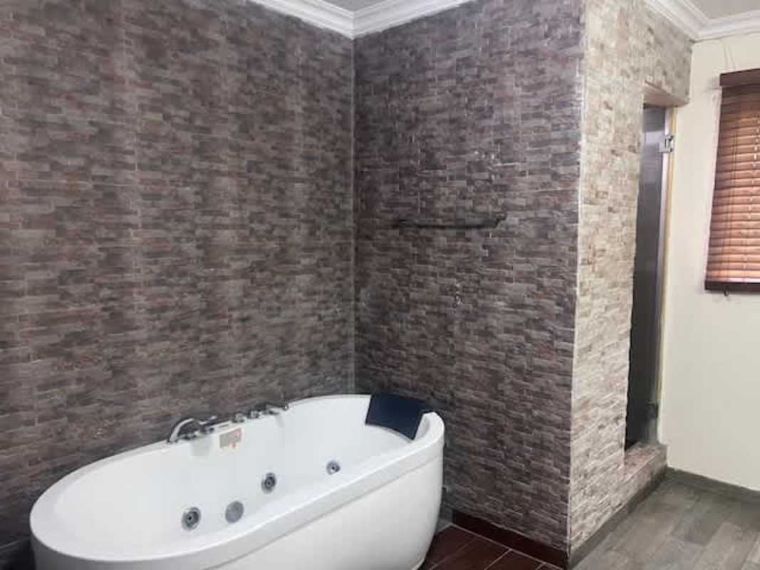 Contemporary bathroom with frosted glass shower, sink and mirror Villa Zaita Panama house