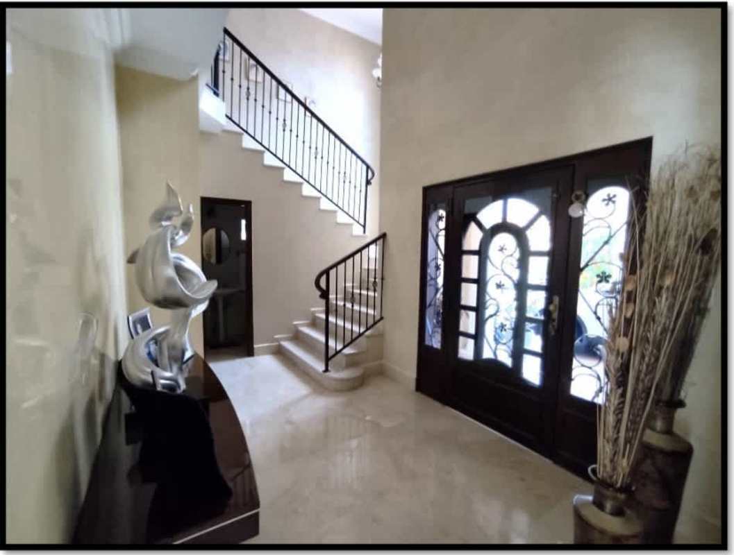 Modern dining area with large glass sliding doors opening to pool terrace Palmeras del Este Costa del Este Panama