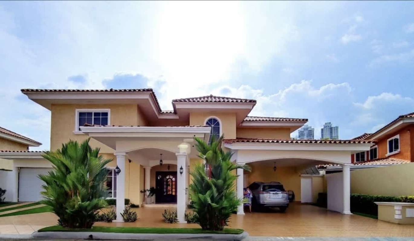 Two-story Mediterranean house with arched windows, red tile roof in Palmeras del Este Costa del Este Panama