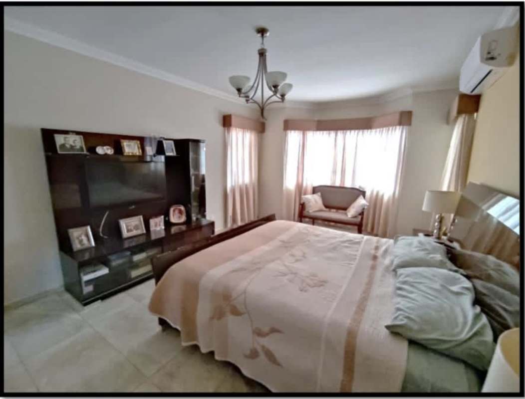 Traditional bedroom with king bed, chandelier, seating and TV unit Palmeras del Este Costa del Este