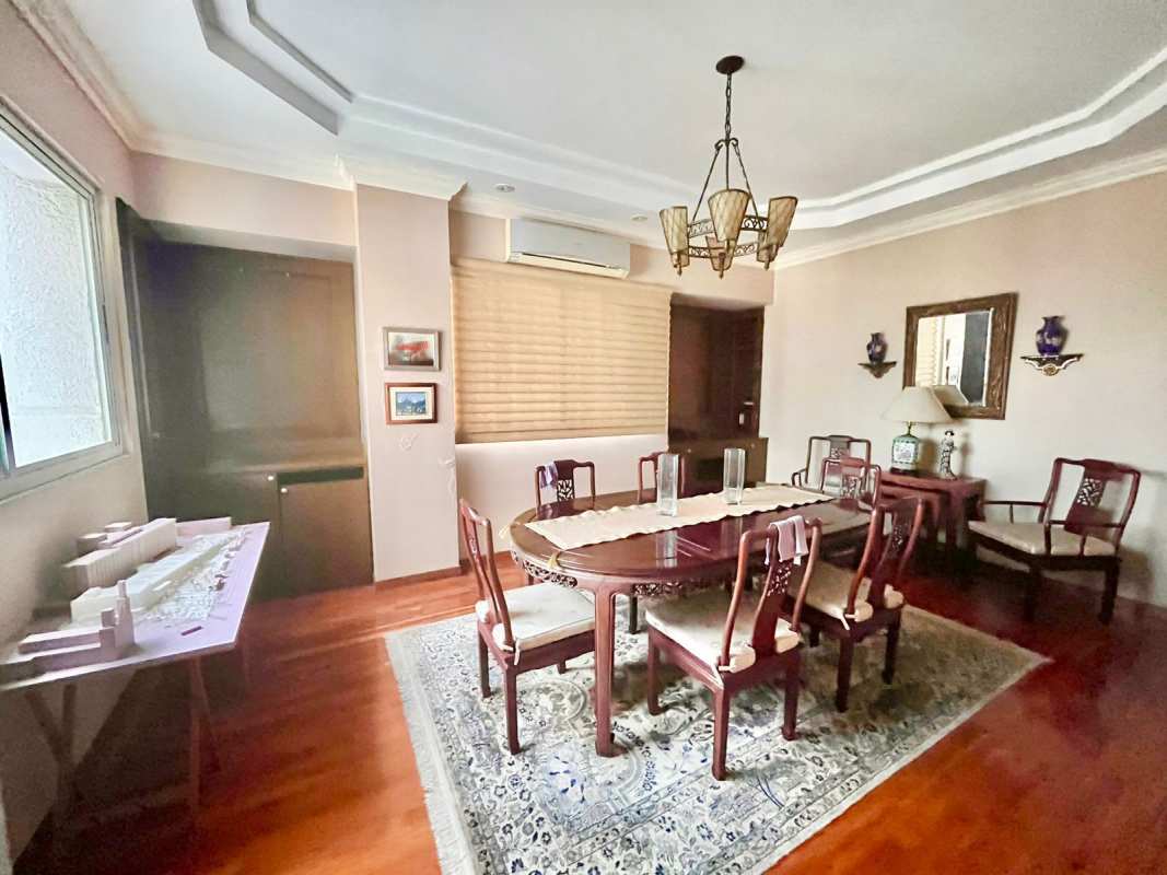 Elegant dining area with chandelier, wooden table, wall decor at PH Victoria Tower Obarrio