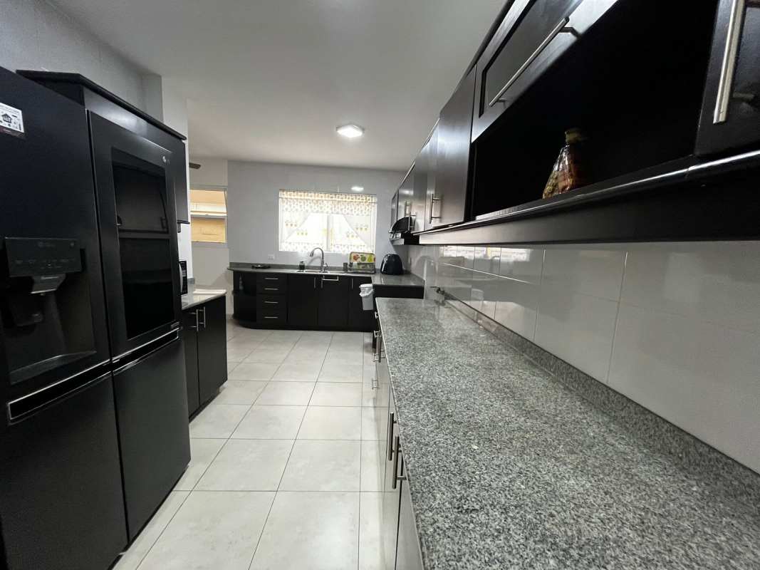 Bedroom with workspace, large window blinds, desk and modern decor PH Villa Alta Brisas del Golf Panama