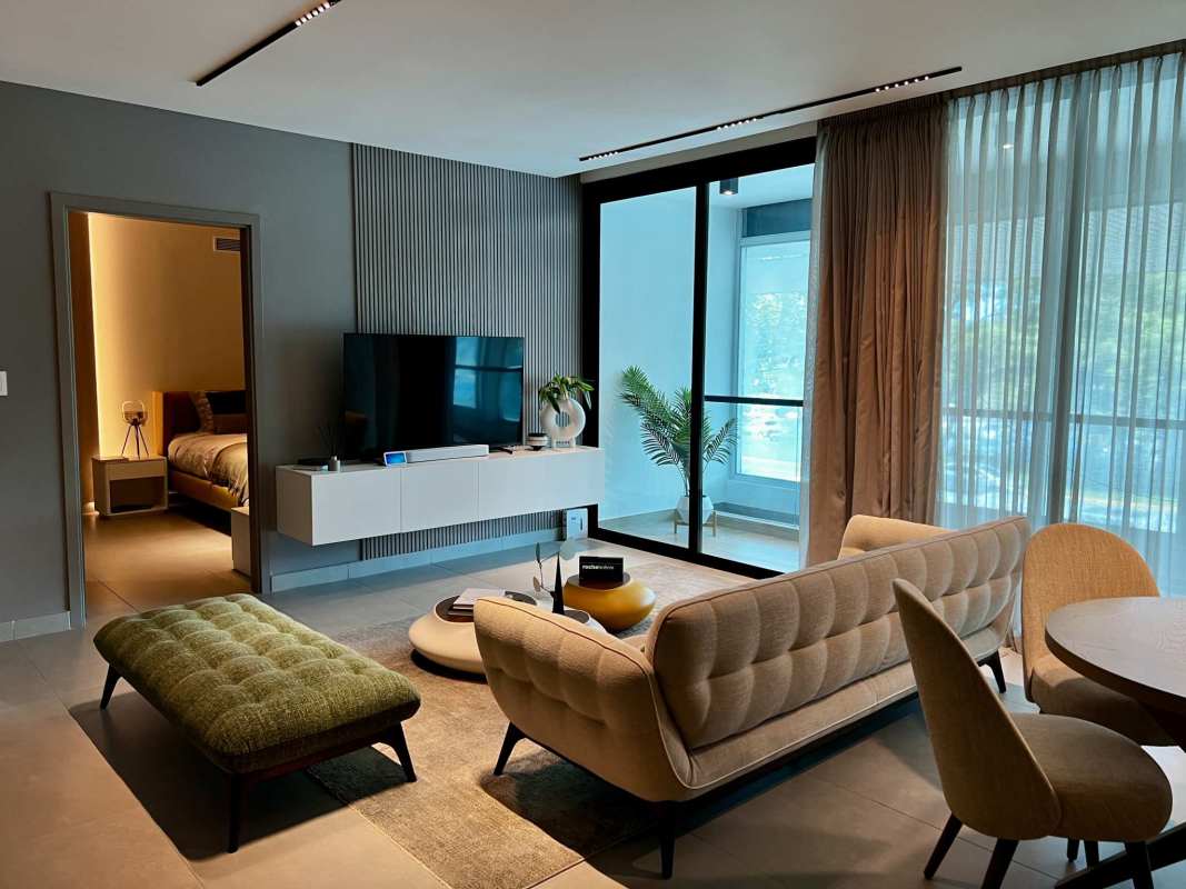 Modern living and dining area with floor-to-ceiling windows, designer furniture, balcony access in PH Uruguay Bella Vista Panama