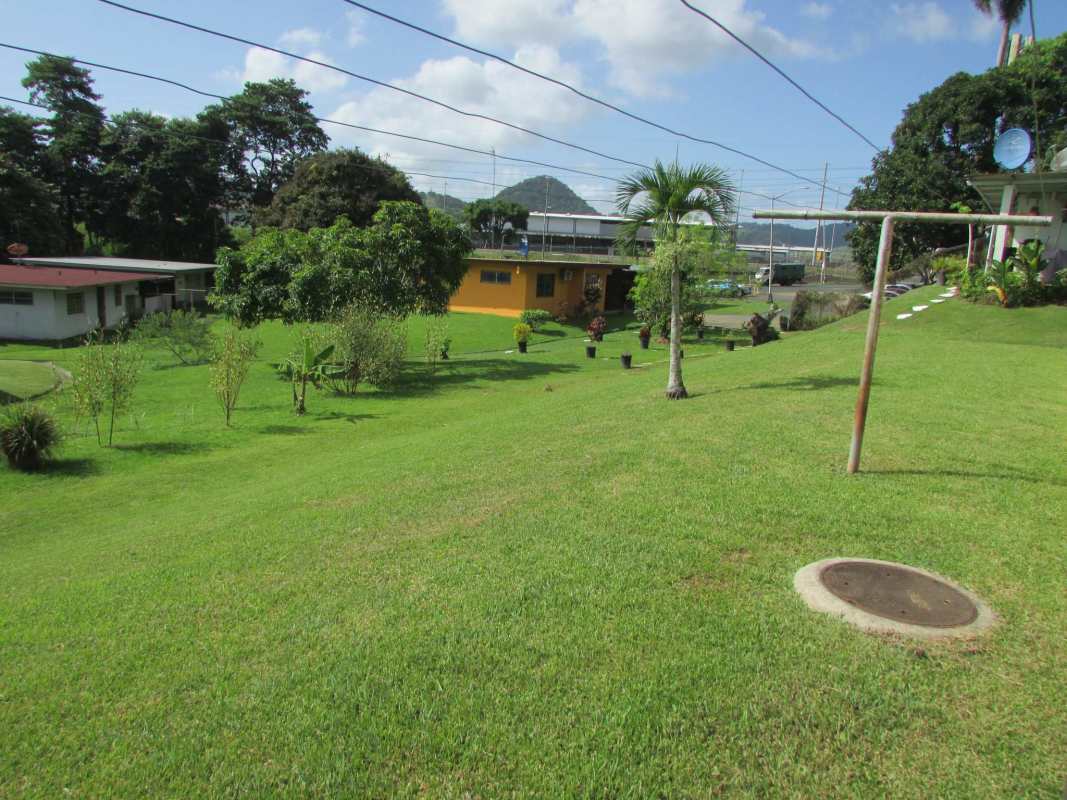 Yellow single-story house large green yard trees Pedro Miguel Clayton area Panama