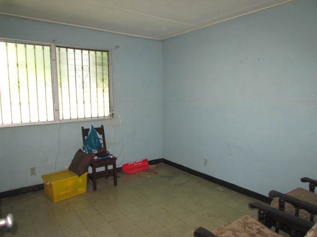 Secondary living room with blue walls window bars and tile floor house Pedro Miguel Panama