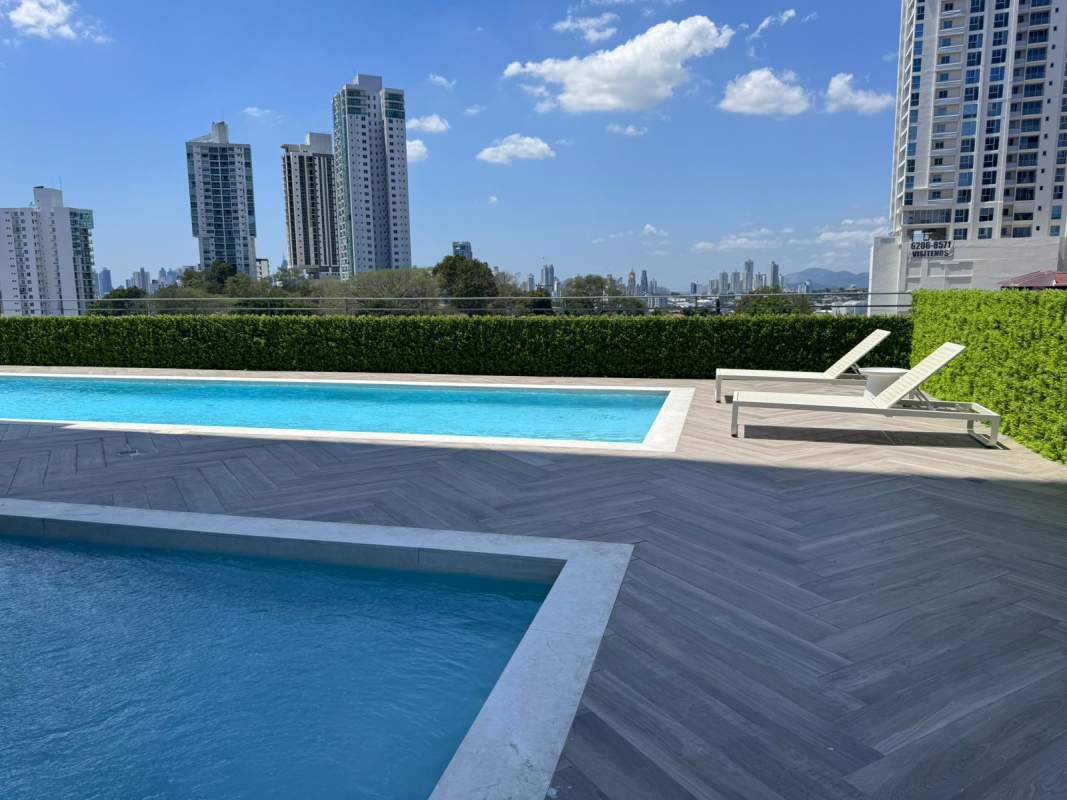 Rooftop double swimming pools and sun deck with skyline view at PH Centerpoint Panama