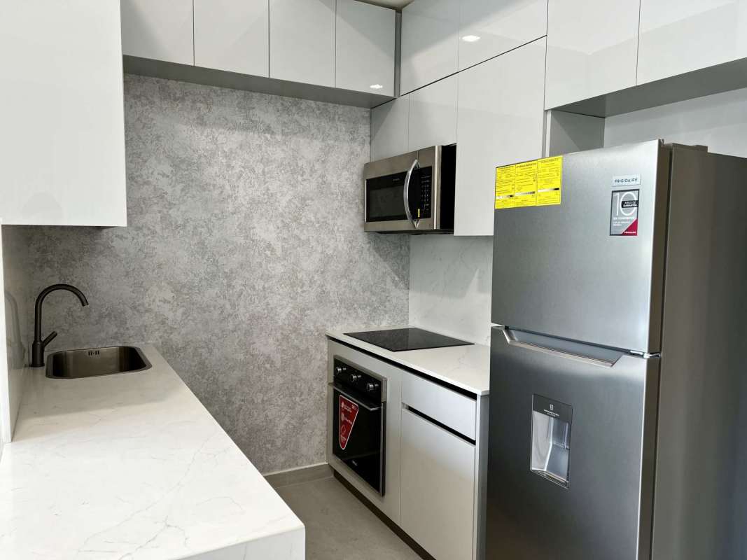 Modern kitchen with marble counter and stainless steel appliances in Bella Vista Panama City