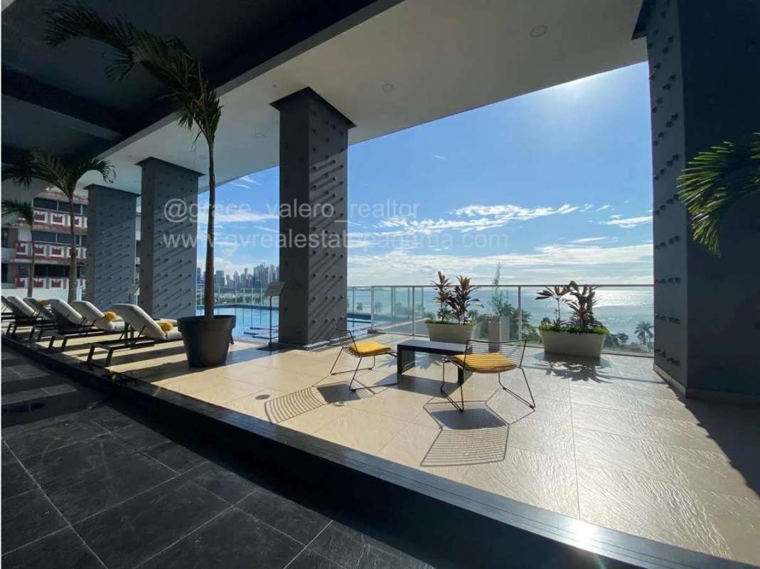 Elegant covered terrace with ocean panorama, glass railing, skyline backdrop in PH Element Panama
