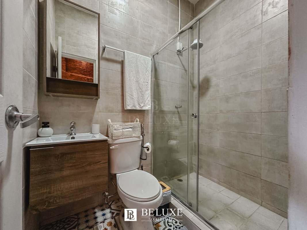 Bathroom with glass shower tiled walls vanity mirror PH Casa Santana Panama