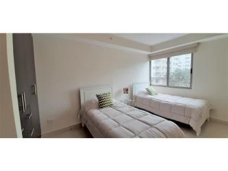 Modern kitchen with granite countertops and stainless appliances in Woodlands condo Panama Pacifico