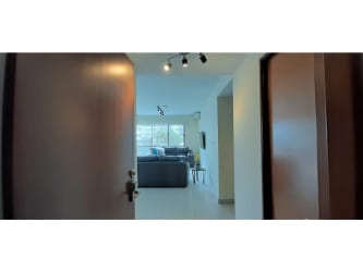 Outdoor swimming pool with lounging area at Midrise Woodlands condo Panama Pacifico