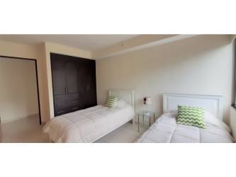 Furnished master bedroom with walk-in closet and ensuite bath in Midrise Woodlands Panama Pacifico