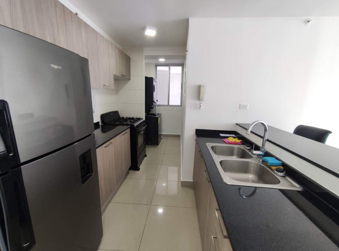 Kitchen with granite countertops and stainless fridge in PH Coral Tower Panama City
