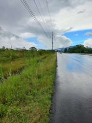 Road frontage along Boquete highway with utility poles and mountain backdrop