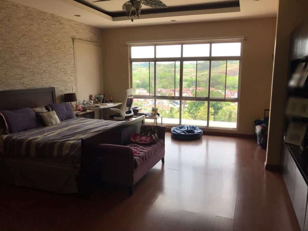 Contemporary two-story house exterior with balcony, patio and large windows in Altos de Panamá Panama