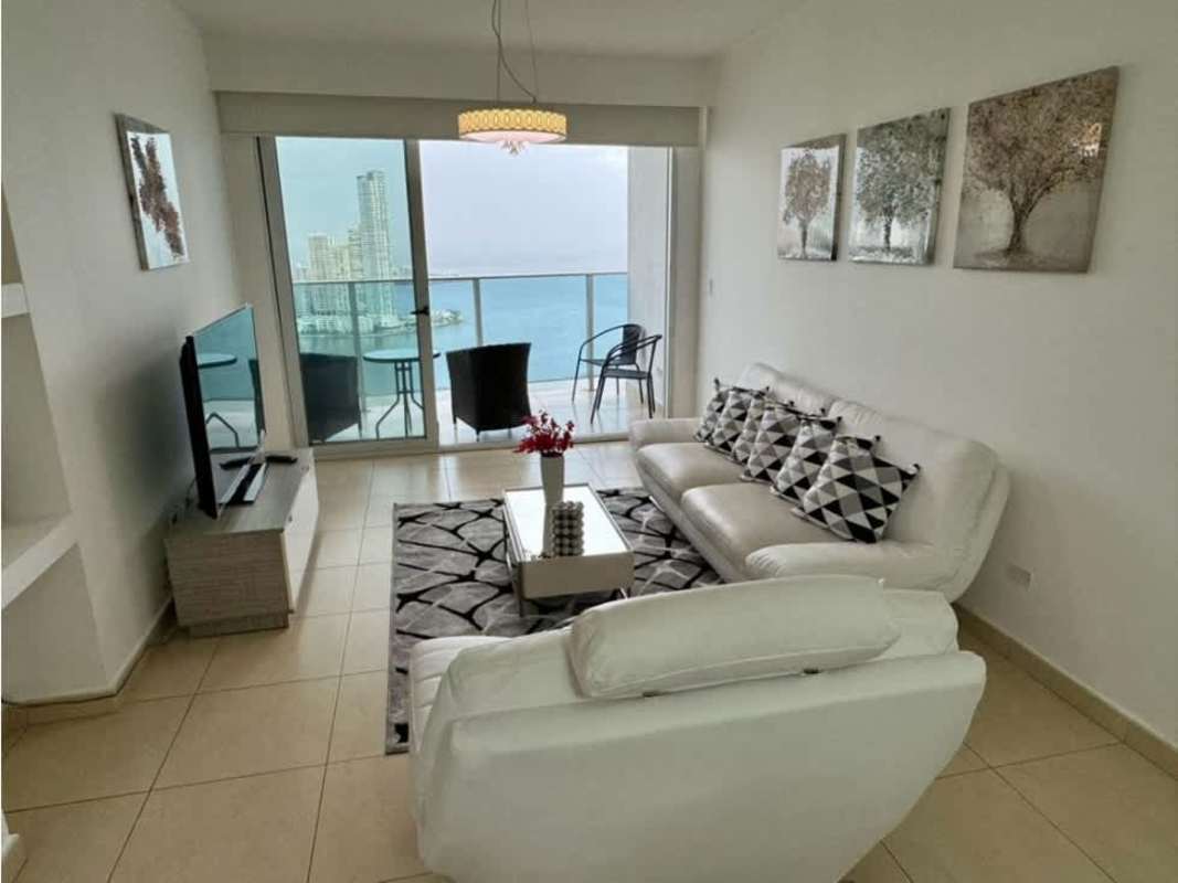 Bright living area with sofas and balcony overlooking ocean at PH BICSA Avenida Balboa