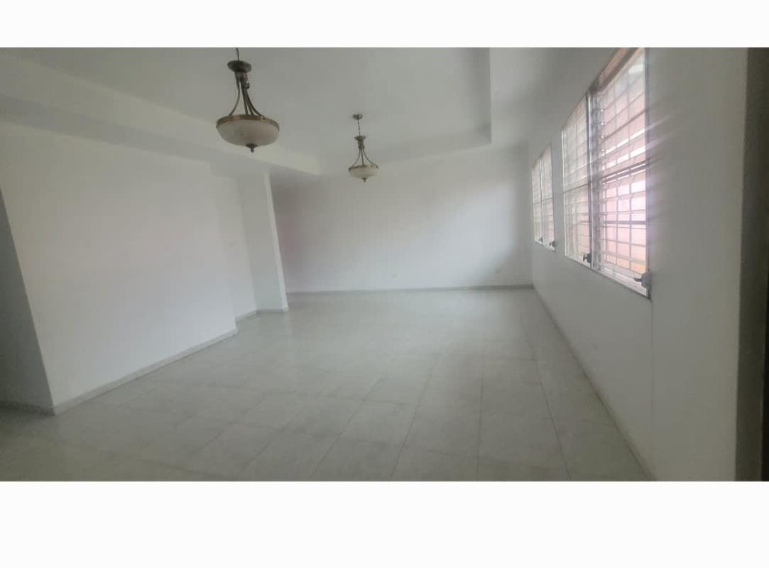 Empty living and dining room with large windows and tiled floors in Las Quintas San Antonio Panama