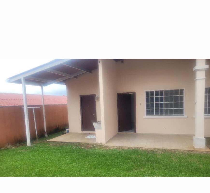 Exterior of single-story house with covered carport and front garden in Las Quintas San Antonio Panama