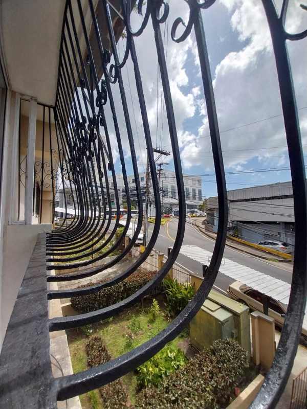 Secure metal grille gate in corridor with light window Panama apartment rental