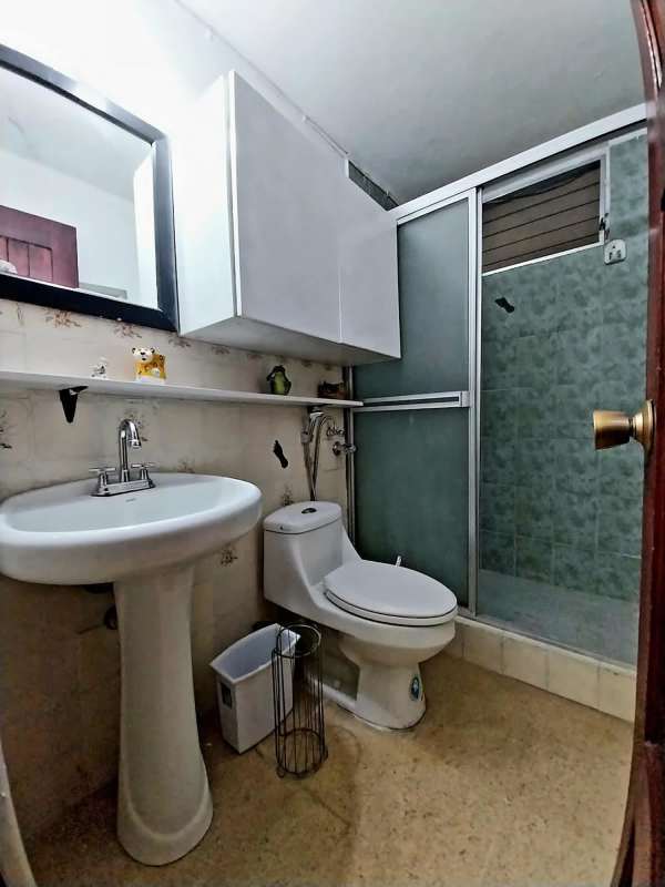 Balcony iron railing with view of gardens and surrounding buildings in Panama City