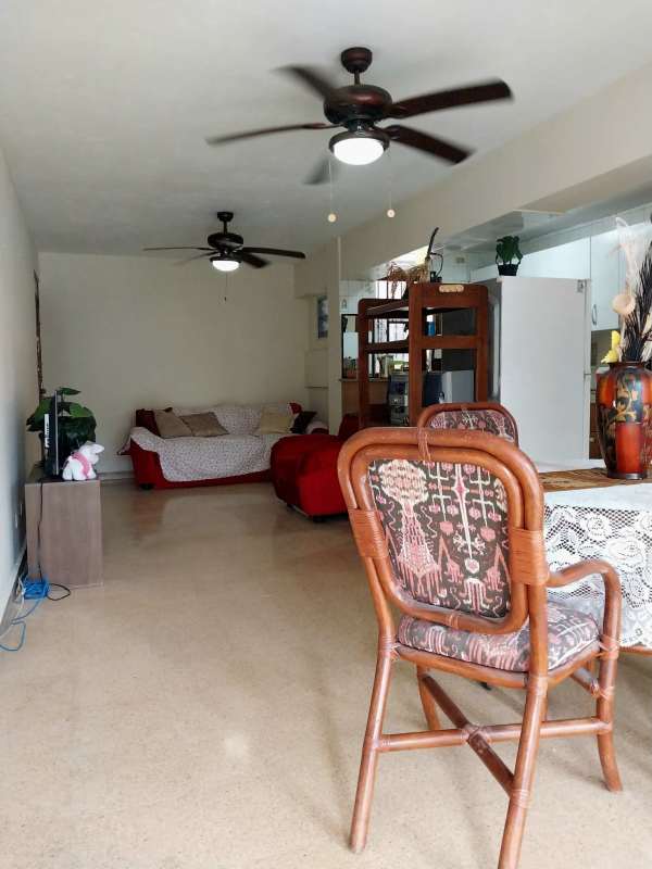 Open living and dining room with ceiling fans seating area in Panama furnished apartment