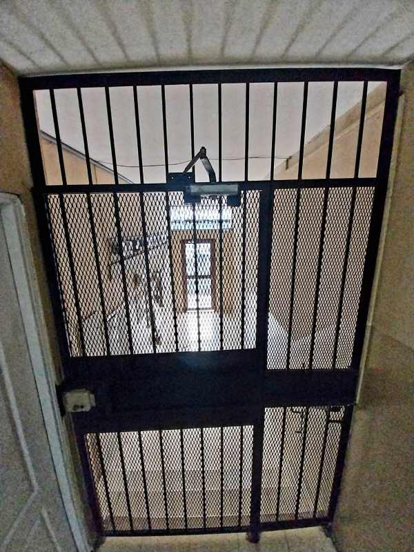 Traditional bathroom with pedestal sink toilet enclosed shower in Panama apartment