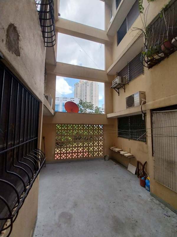 Exterior open corridor with AC units satellite dish and utility area in apartment building Panama