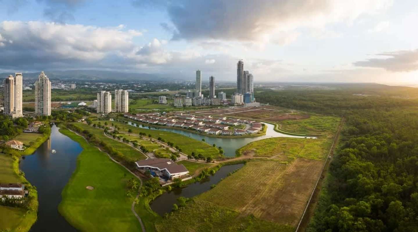 Modern villas and multi-story towers by lakefront at Peninsula Estates Santa Maria Panama City