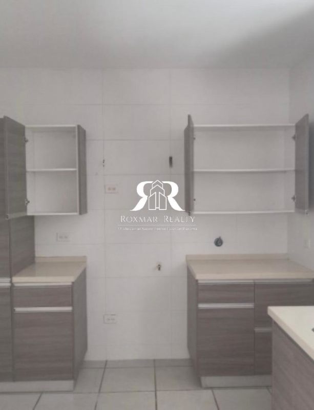 Modern ceramic tile kitchen with upper open cabinets in house for sale Brisas del Golf Panama