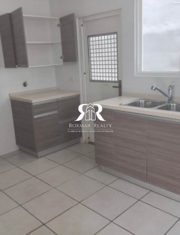 Modern open kitchen ceramic tiles wood cabinets double sink window Brisas del Golf Panama