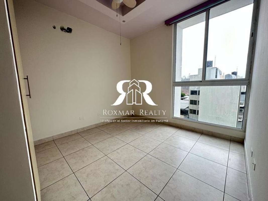 Bright bedroom with large window, ceiling fan, closets PH Lexington El Cangrejo Panama City