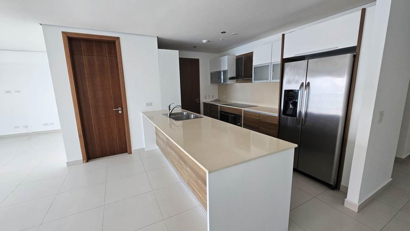 Open kitchen with granite countertops, stainless appliances and breakfast bar in Parkside Costa del Este