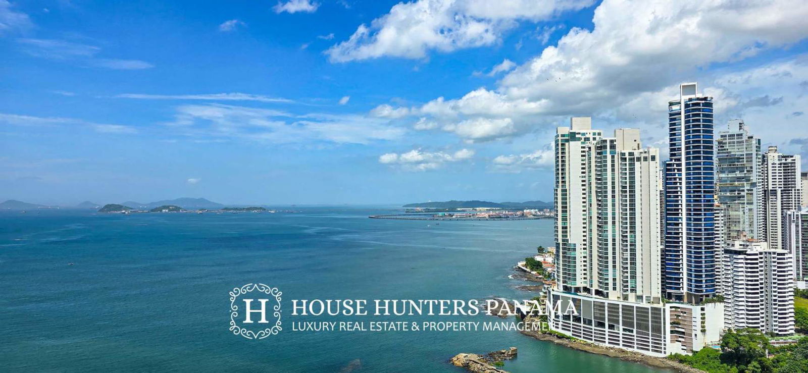 Luxury bathroom with granite countertops, double sinks, and glass-enclosed shower in PH Aqualina