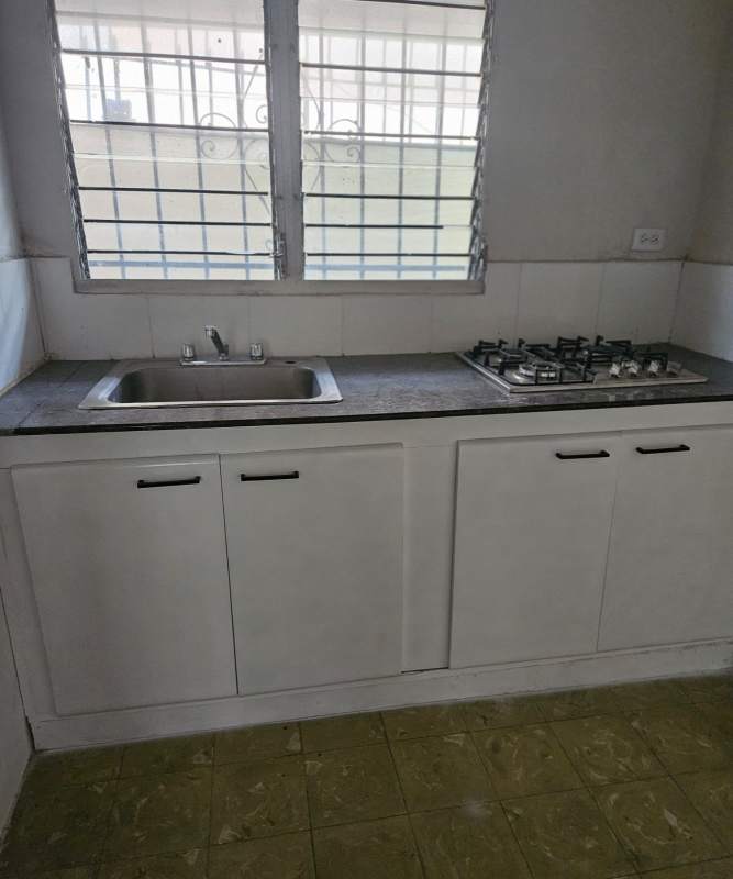 Bedroom with built-in closet, tile flooring, barred windows in house for rent Bella Vista Panama