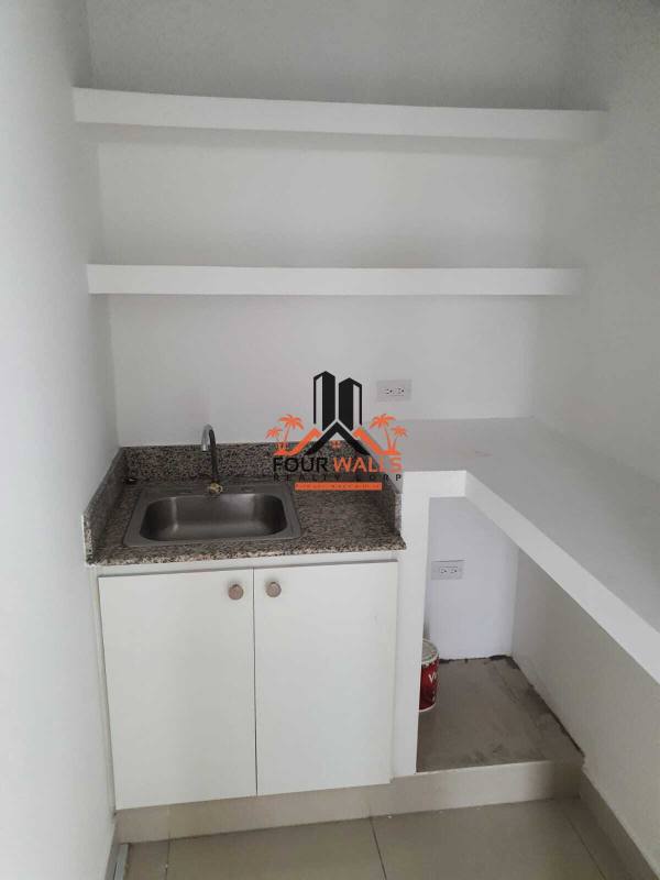 Utility area with granite countertop and sink in PH BOC office Panama City