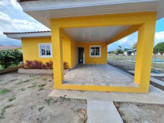 Open living dining space with ceramic tile in new Santa Clara beach house