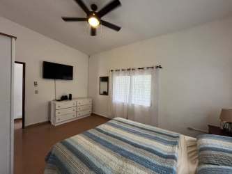 Large bedroom with windows garden view ceiling fan Playa Corona beach house
