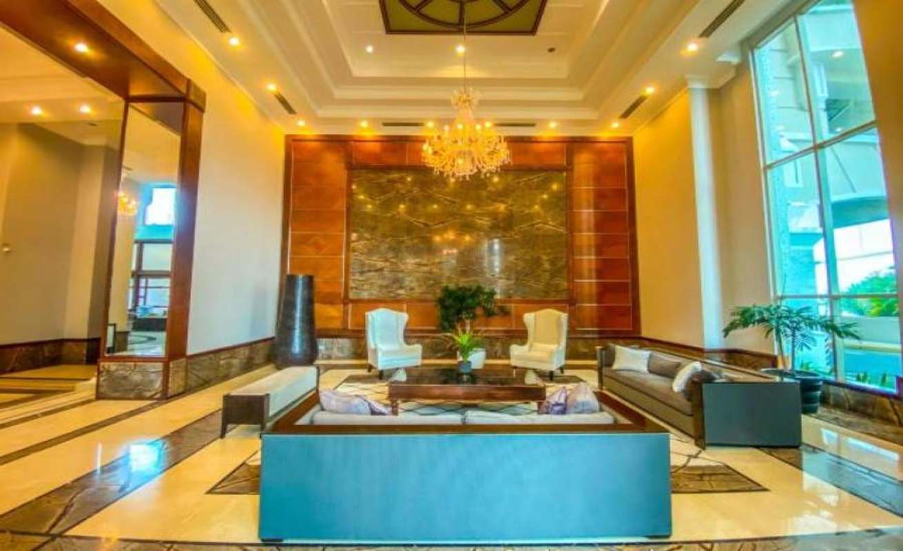 Elegant spacious lobby with marble accents chandelier and modern design at PH Pacific Point Panama City