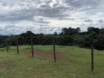 Flat grassy development land with views of surrounding mountains in Santa Rita La Chorrera Panama