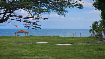 Green yard leading to Pacific beach with small gazebo Coronado Panama