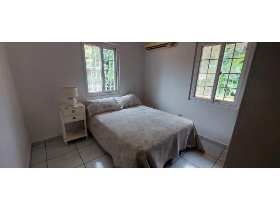 Main entrance with wood door and minimal décor Condado del Rey residence