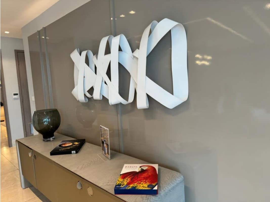 Modern condo hallway with abstract sculpture and glossy walls PH Delux Punta Paitilla Panama