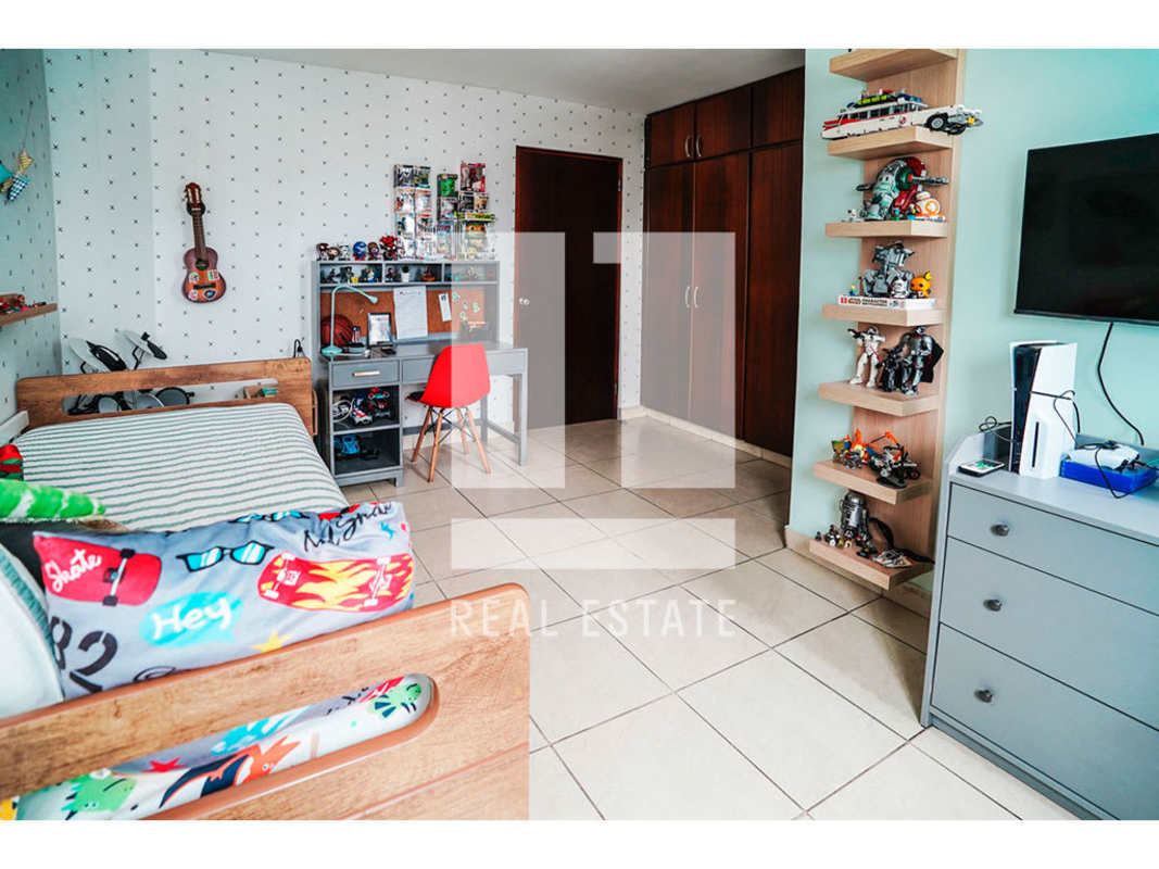 Bright children's bedroom with bed, study desk, shelving and toys PH Bahia Obarrio Panama