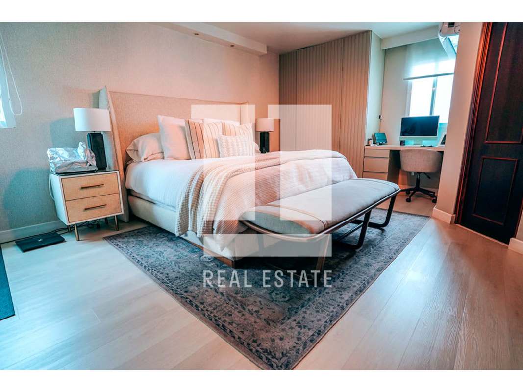 Bedroom with built-in desk, TV, AC unit, wood dresser PH Bahia Obarrio Panama