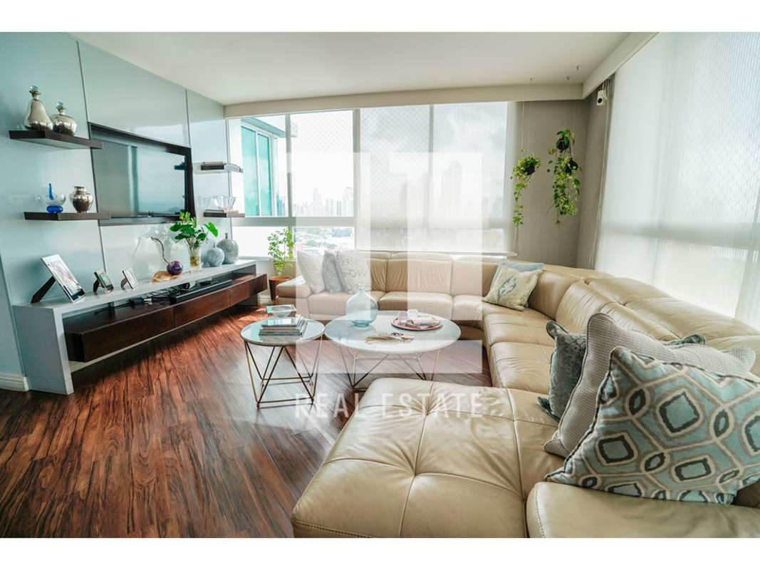 Modern dining room with glass table, upholstered chairs, wood flooring, PH Bahia Obarrio Panama