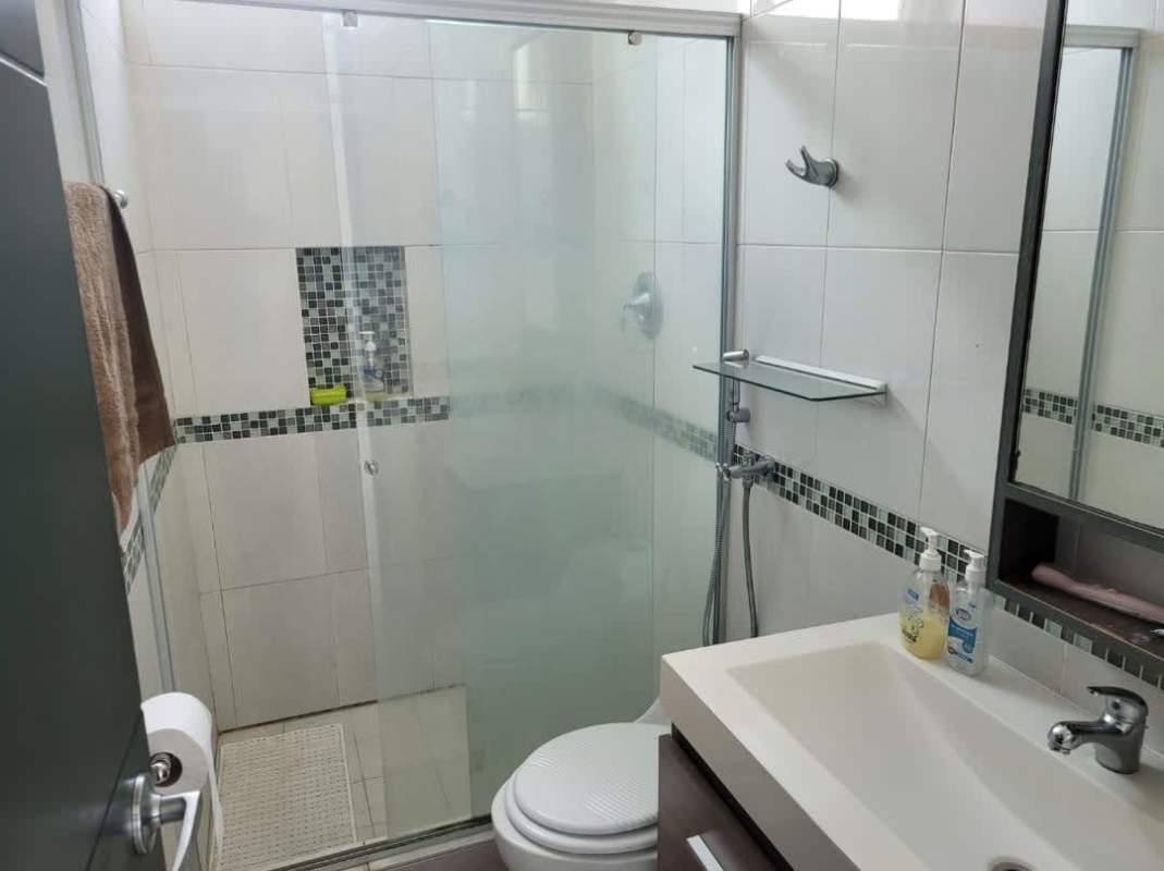 Modern bathroom with glass-enclosed shower, vanity and tiles in Edison Park Tower Panama