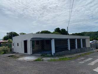 Single-story beige bungalow house with garden area wall in Dolega, Chiriquí Panama
